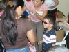 Dr. Betty Vo fitting eyeglasses on a child while mom watches Dr. Betty Vo fitting eyeglasses on a child while mom watches